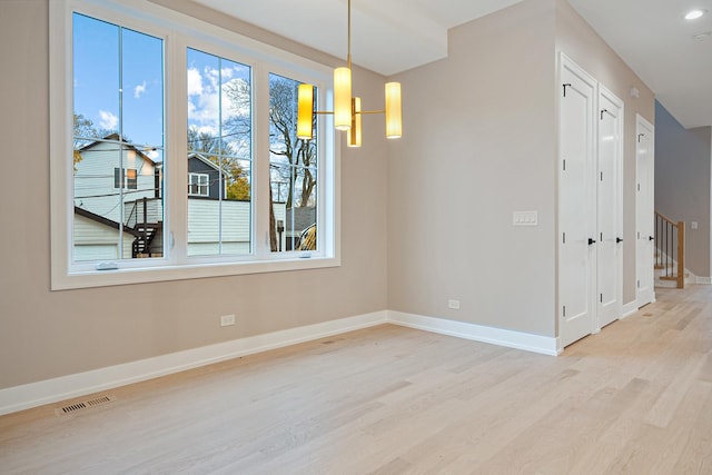 2218 W Oakdale Ave, Chicago, IL 60618 - unfurnished dining area featuring light wood-type flooring and baseboards