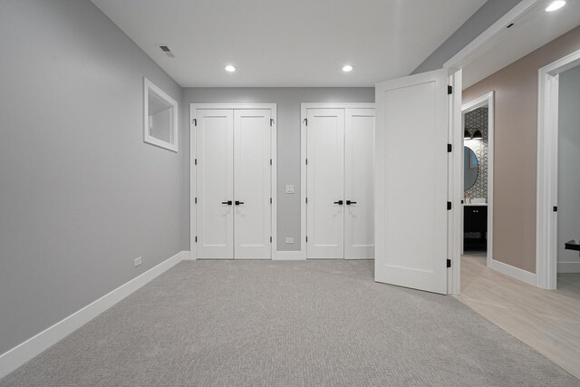 2218 W Oakdale Ave, Chicago, IL 60618 - unfurnished bedroom featuring two closets, recessed lighting, light colored carpet, and ensuite bathroom