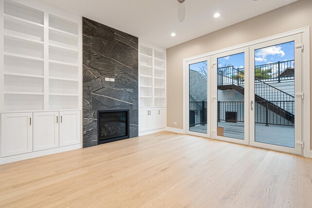 2218 W Oakdale Ave, Chicago, IL 60618 - unfurnished living room with built in features, wood finished floors, a fireplace, recessed lighting, and a ceiling fan