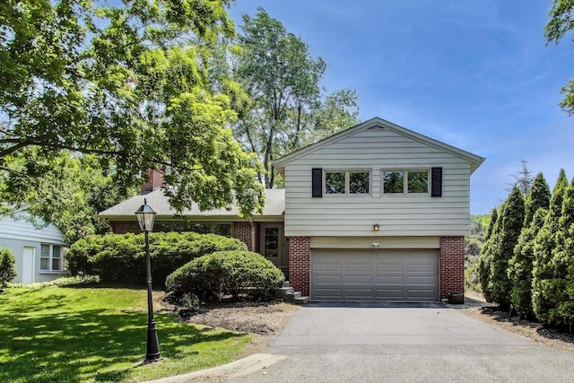 471 Highcrest Dr, Wilmette, IL 60091 - split level home with brick siding, an attached garage, asphalt driveway, and a front lawn
