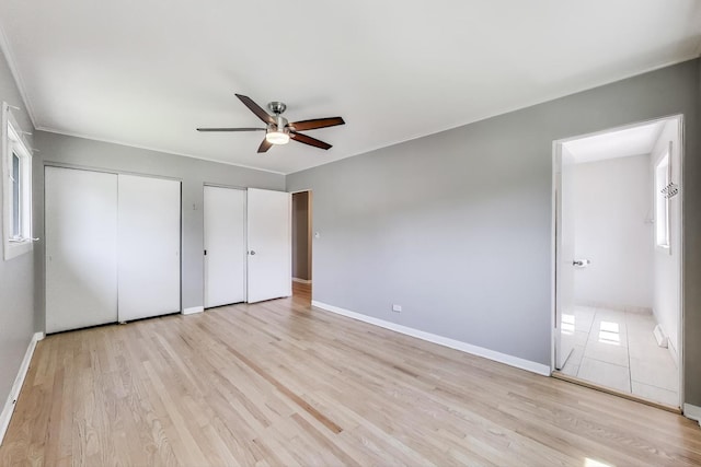 471 Highcrest Dr, Wilmette, IL 60091 - unfurnished bedroom featuring multiple closets, light wood-style flooring, and a ceiling fan