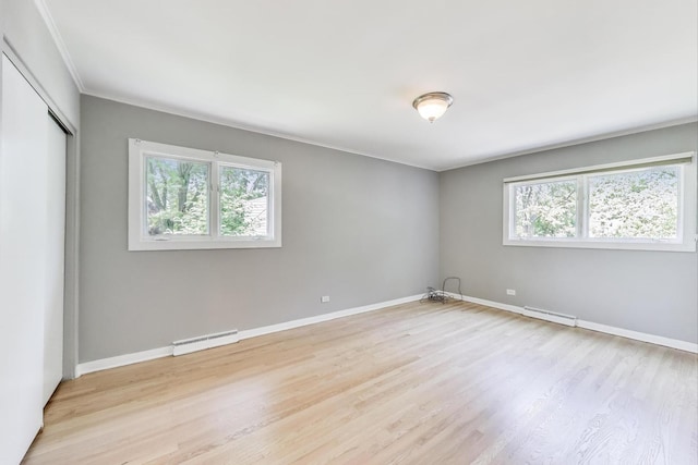 471 Highcrest Dr, Wilmette, IL 60091 - unfurnished bedroom with light wood-style flooring, a baseboard radiator, a closet, and ornamental molding