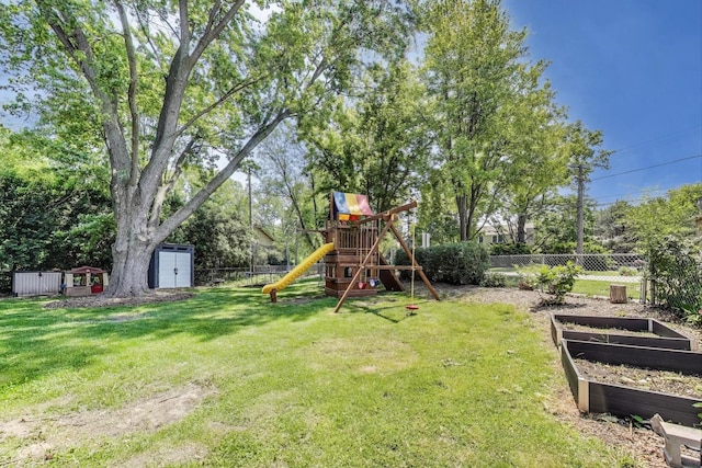 471 Highcrest Dr, Wilmette, IL 60091 - view of yard featuring a storage unit, a playground, a garden, and view of wooded area