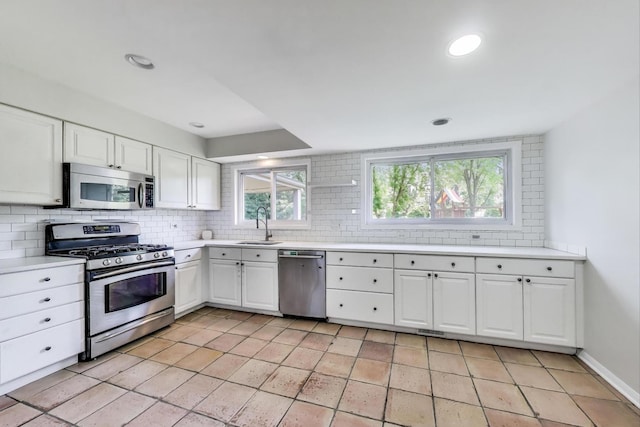 471 Highcrest Dr, Wilmette, IL 60091 - kitchen featuring appliances with stainless steel finishes, backsplash, light countertops, white cabinets, and recessed lighting