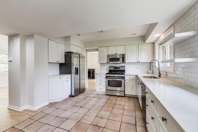 471 Highcrest Dr, Wilmette, IL 60091 - kitchen featuring stainless steel appliances, backsplash, white cabinets, light tile patterned floors, and recessed lighting