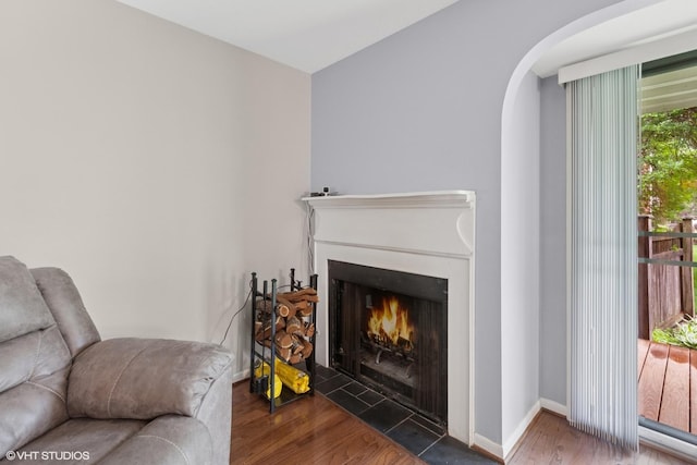 1521 S County Farm Rd Unit 1-3C, Wheaton, IL 60189 - living area with wood finished floors, arched walkways, and a fireplace with flush hearth