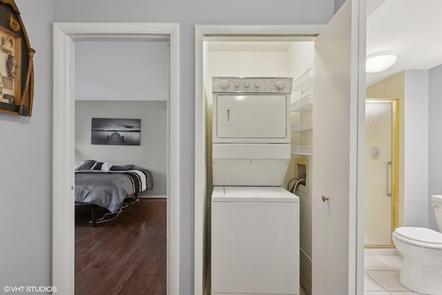 1521 S County Farm Rd Unit 1-3C, Wheaton, IL 60189 - washroom featuring stacked washer / drying machine and wood finished floors