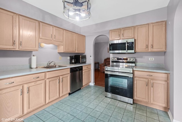 1521 S County Farm Rd Unit 1-3C, Wheaton, IL 60189 - kitchen with appliances with stainless steel finishes, light brown cabinets, and arched walkways