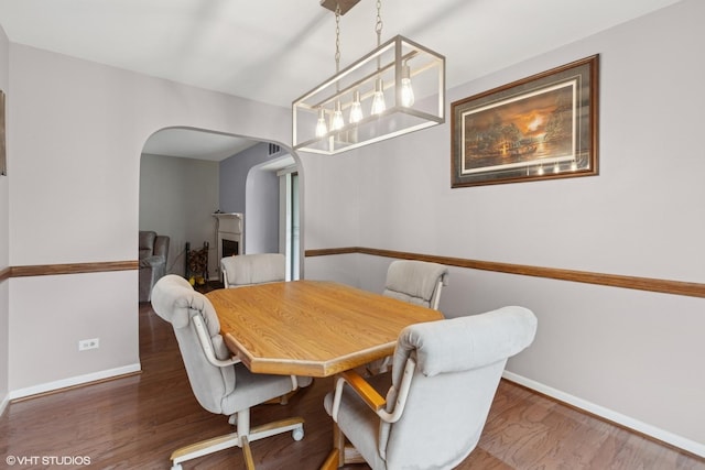 1521 S County Farm Rd Unit 1-3C, Wheaton, IL 60189 - dining space featuring arched walkways and wood finished floors