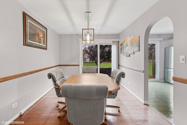 1521 S County Farm Rd Unit 1-3C, Wheaton, IL 60189 - dining area with arched walkways and wood finished floors