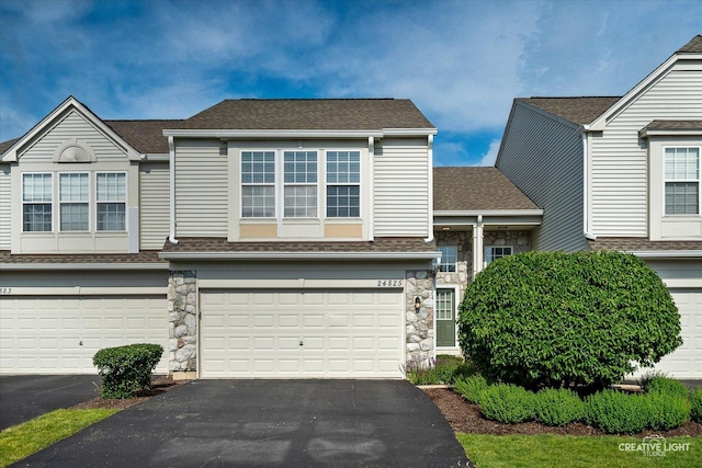 24825 W Gates Ct, Plainfield, IL 60585 - townhome / multi-family property with asphalt driveway, stone siding, an attached garage, and a shingled roof