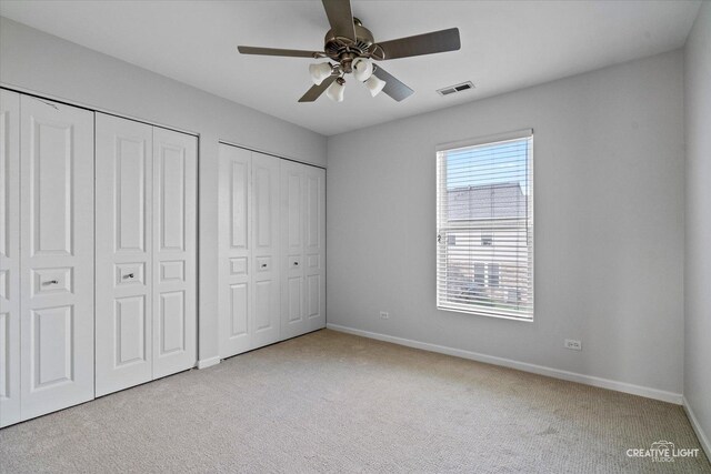 24825 W Gates Ct, Plainfield, IL 60585 - unfurnished bedroom featuring two closets, carpet floors, and ceiling fan