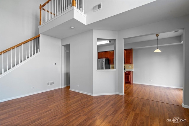 24825 W Gates Ct, Plainfield, IL 60585 - unfurnished living room with stairway, dark wood-style flooring, and a high ceiling