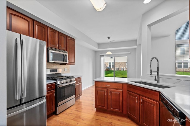 24825 W Gates Ct, Plainfield, IL 60585 - kitchen featuring stainless steel appliances, light wood finished floors, light countertops, and backsplash