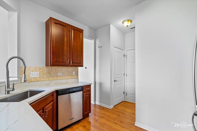 24825 W Gates Ct, Plainfield, IL 60585 - kitchen with dishwasher, light wood-style floors, light stone counters, and tasteful backsplash