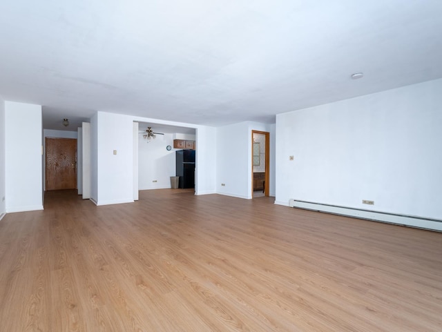 8005 W Oconnor Dr Unit 4E, River Grove, IL 60171 - unfurnished living room with a baseboard heating unit and light wood-style flooring