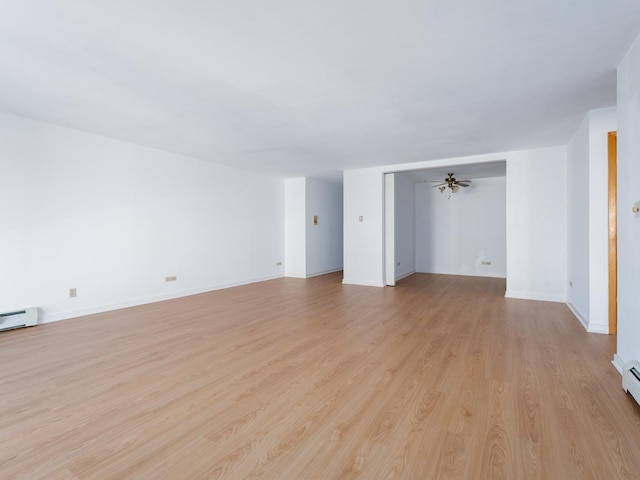 8005 W Oconnor Dr Unit 4E, River Grove, IL 60171 - unfurnished living room featuring light wood-type flooring and a baseboard heating unit