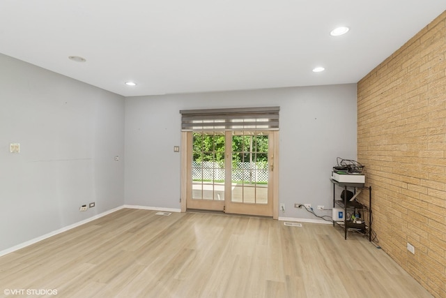 3071 Plum Island Dr, Northbrook, IL 60062 - spare room with light wood-type flooring, recessed lighting, and brick wall