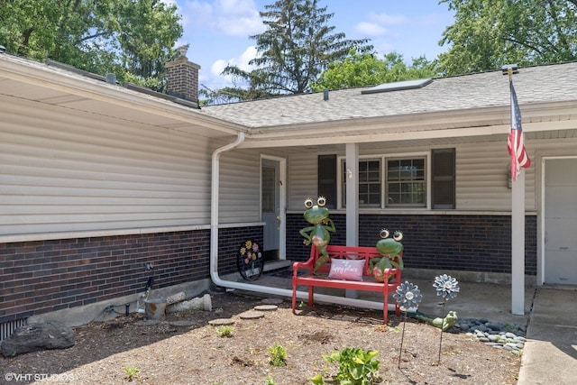 3071 Plum Island Dr, Northbrook, IL 60062 - property entrance featuring a porch, a chimney, brick siding, and a shingled roof