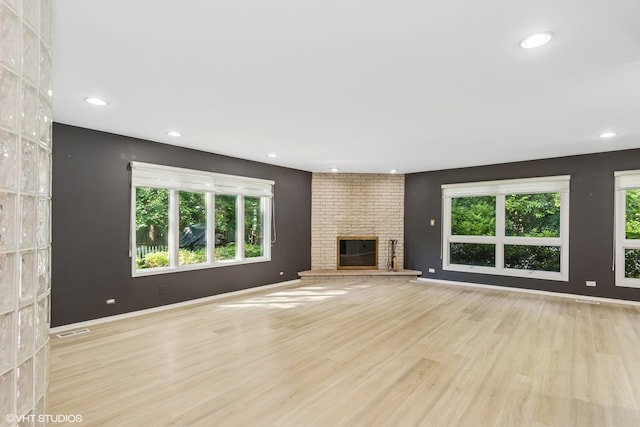 3071 Plum Island Dr, Northbrook, IL 60062 - unfurnished living room with wood finished floors, plenty of natural light, a brick fireplace, and recessed lighting