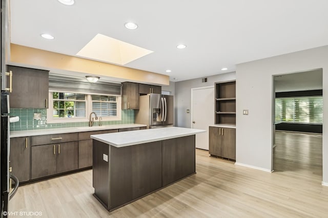 3071 Plum Island Dr, Northbrook, IL 60062 - kitchen featuring stainless steel fridge, light countertops, dark brown cabinets, a kitchen island, and recessed lighting