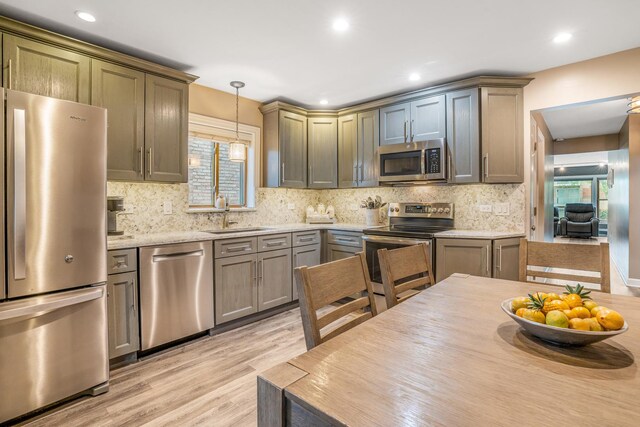 2241 S 17th Ave, North Riverside, IL 60546 - kitchen with stainless steel appliances, light wood-style flooring, decorative light fixtures, backsplash, and recessed lighting