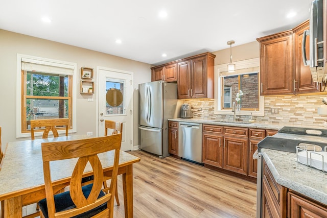 2241 S 17th Ave, North Riverside, IL 60546 - kitchen with stainless steel appliances, tasteful backsplash, light wood-style flooring, brown cabinetry, and pendant lighting