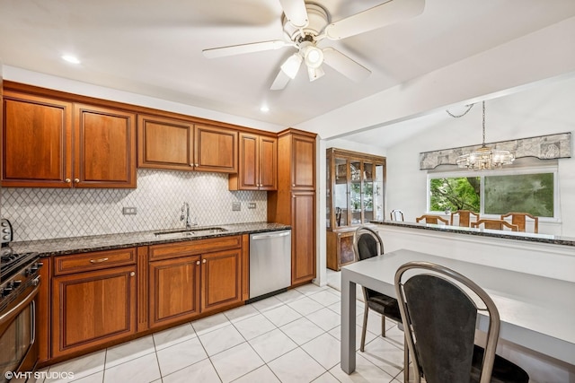 1508 Seville Ct Unit D2, Wheeling, IL 60090 - kitchen featuring stainless steel appliances, backsplash, brown cabinets, vaulted ceiling, and dark stone countertops