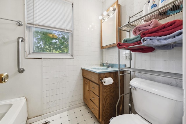 525 Munroe St, Joliet, IL 60436 - bathroom featuring vanity, tile patterned floors, and tile walls