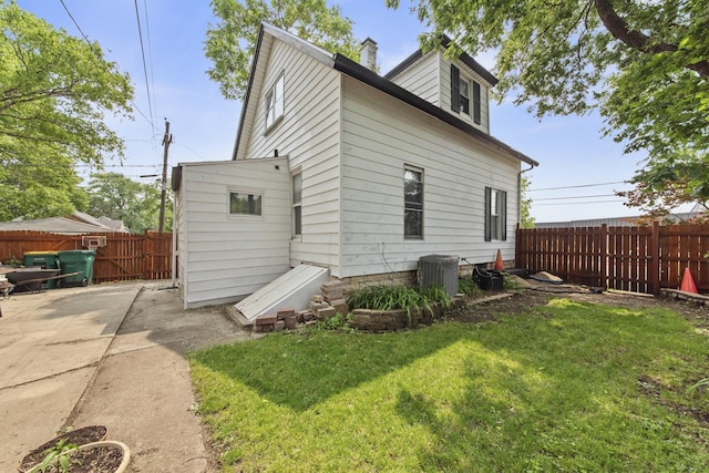 525 Munroe St, Joliet, IL 60436 - rear view of house with a fenced backyard, a patio, and a chimney