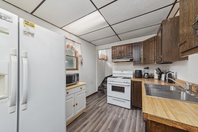 525 Munroe St, Joliet, IL 60436 - kitchen with white appliances, under cabinet range hood, wood finished floors, a drop ceiling, and dark brown cabinets