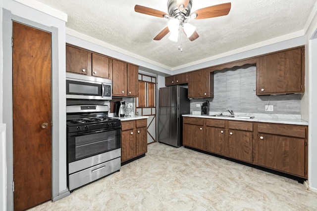 1320 Lore Ln Unit 2-201, Lombard, IL 60148 - kitchen with appliances with stainless steel finishes, a textured ceiling, light countertops, a ceiling fan, and light flooring