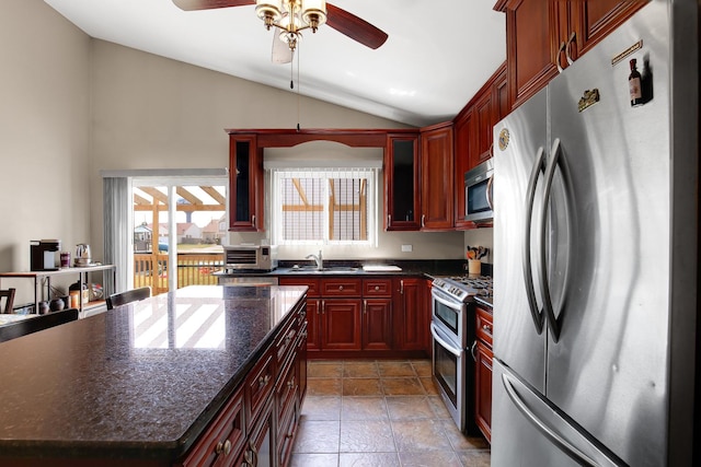 21023 Siegel Dr, Crest Hill, IL 60403 - kitchen featuring stainless steel appliances, dark brown cabinets, vaulted ceiling, plenty of natural light, and ceiling fan