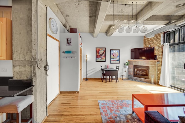 6135 N Broadway St Unit 303, Chicago, IL 60660 - living area with light wood-style flooring and a brick fireplace