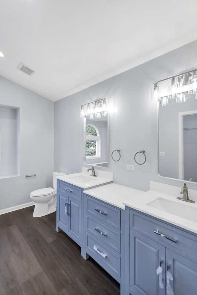 8 Cheswick Ct, Schaumburg, IL 60194 - full bathroom with double vanity, wood finished floors, and lofted ceiling