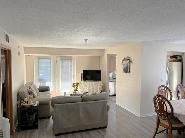 231 N Mill Rd Unit 11, Addison, IL 60101 - living room with wood finished floors and a textured ceiling
