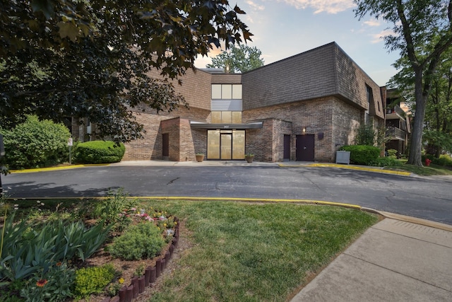 907 S Williams St Unit 206, Westmont, IL 60559 - view of front of house with brick siding, mansard roof, and roof with shingles