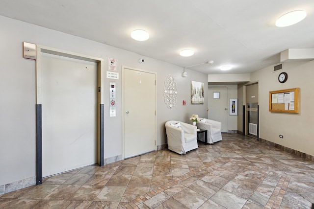 907 S Williams St Unit 206, Westmont, IL 60559 - below grade area with elevator and light stone finish floors