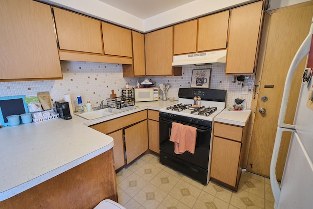 6101 N Elston Ave Unit 3E, Chicago, IL 60646 - kitchen with white appliances, under cabinet range hood, backsplash, and light countertops