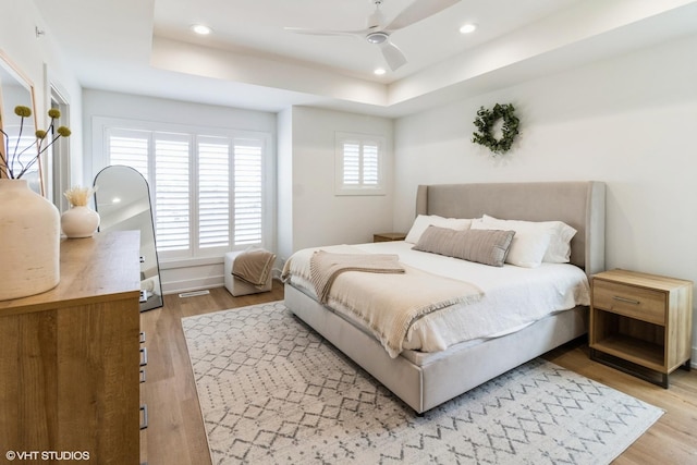 1 N Beverly Ln, Arlington Heights, IL 60004 - bedroom with light wood finished floors, recessed lighting, a tray ceiling, and a ceiling fan
