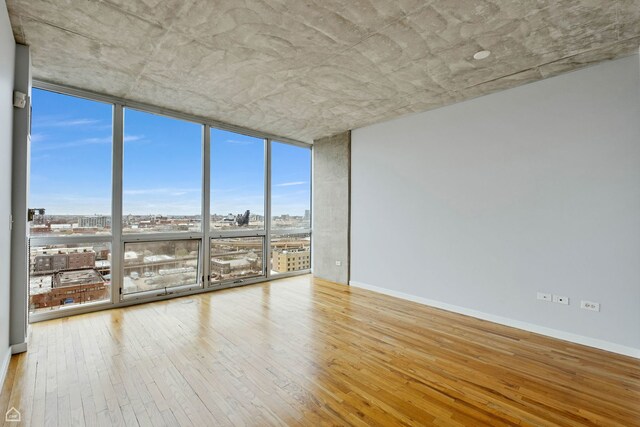 1845 S Michigan Ave Unit 1602, Chicago, IL 60616 - empty room featuring a wall of windows, wood-type flooring, and a city view