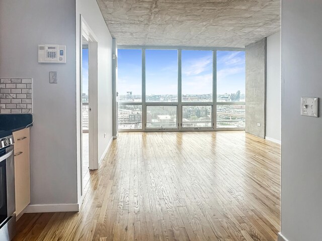1845 S Michigan Ave Unit 1602, Chicago, IL 60616 - unfurnished living room with expansive windows, wood finished floors, and a view of city