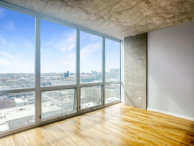 1845 S Michigan Ave Unit 1602, Chicago, IL 60616 - spare room featuring a city view, expansive windows, and wood finished floors