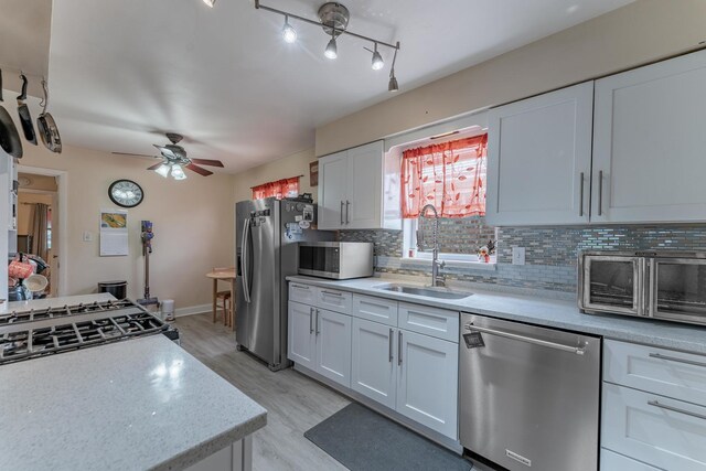 3631 54th Ave, Cicero, IL 60804 - kitchen with appliances with stainless steel finishes, ceiling fan, decorative backsplash, light countertops, and white cabinetry