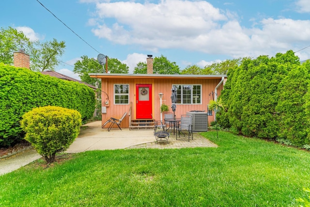 3631 54th Ave, Cicero, IL 60804 - view of front of property with a chimney, entry steps, an outdoor fire pit, a patio area, and a front lawn