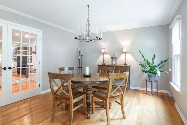 1549 Preston Rd, Naperville, IL 60563 - dining space with light wood-style flooring, a chandelier, plenty of natural light, ornamental molding, and french doors