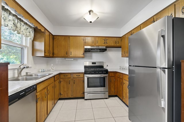 5902 Fox Lake Rd, Mchenry, IL 60051 - kitchen with appliances with stainless steel finishes, under cabinet range hood, brown cabinetry, and light countertops