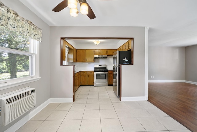 5902 Fox Lake Rd, Mchenry, IL 60051 - kitchen featuring stainless steel appliances, brown cabinetry, under cabinet range hood, a ceiling fan, and light countertops