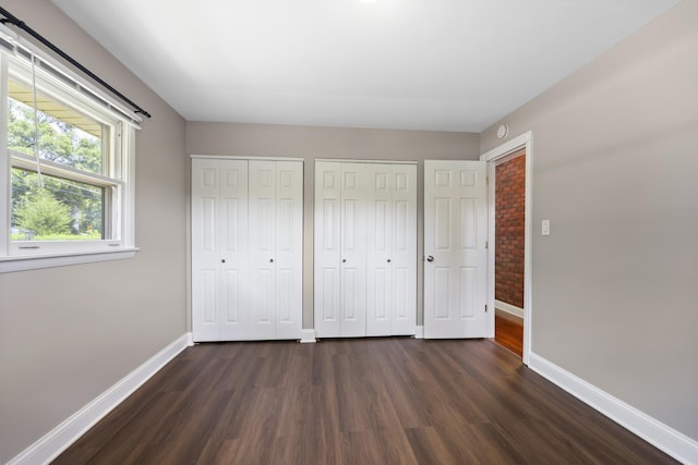 5902 Fox Lake Rd, Mchenry, IL 60051 - unfurnished bedroom with dark wood-type flooring and multiple closets