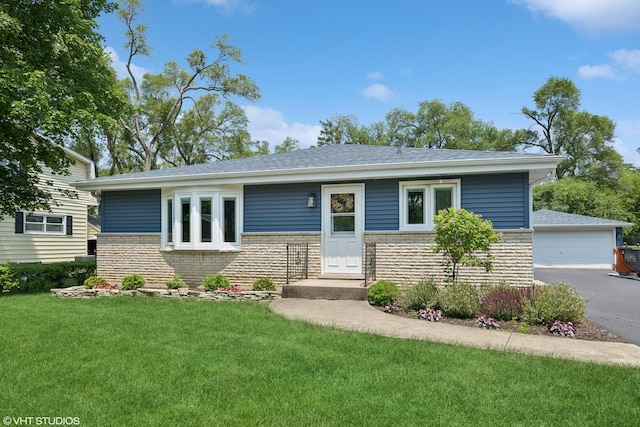 345 Catalpa Ave, Roselle, IL 60172 - view of front of house with brick siding, a front yard, a detached garage, and an outbuilding